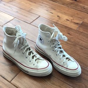 Off-white converse high tops.